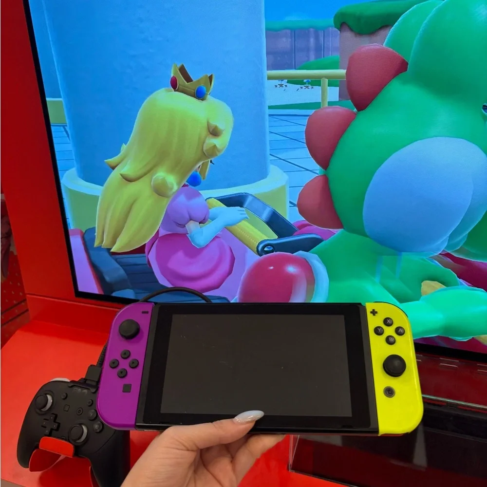 Nintendo Switch with Vibrant Purple and Yellow Joy-Con free games